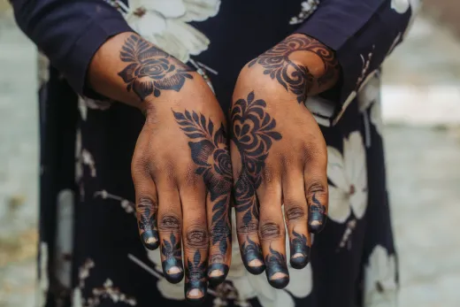 Close up of hands adorned with intricate henna - arabic mehndi