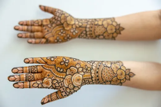 Intricate henna designs on forearms and hands - arabic mehndi
