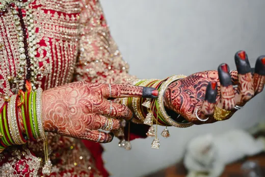 Close up of a bride s hands adorned with intri - bridal mehndi