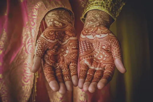 Intricate henna designs on a woman s hands in - bridal mehndi