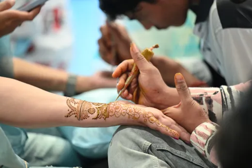 Close up of intricate henna design being appli - bridal mehndi