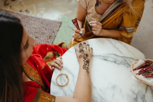 Intricate henna design being applied on a woma - bridal mehndi