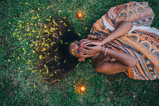 Indian woman lying on grass adorned with henna - henna hair