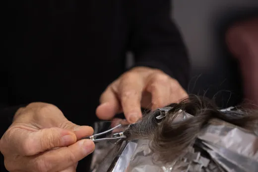 Detailed shot of a hairdresser applying hair c - henna hair colour