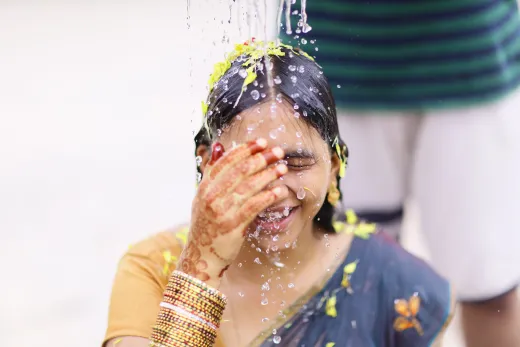 A woman adorned with henna and jewelry enjoys - henna hair
