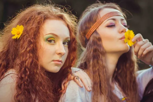 Two young women in bohemian style with flowers - henna hair