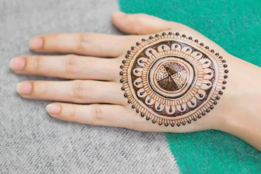 Close up of a woman s hand adorned with a deta - henna stain
