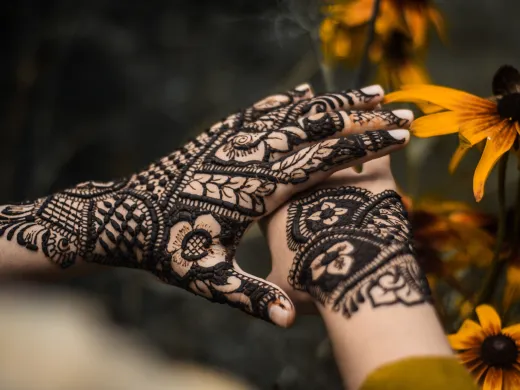 Close up of beautifully decorated hands with h - henna tattoo