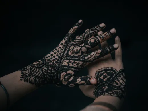 Close up of henna patterns on hands with a dar - henna tattoo