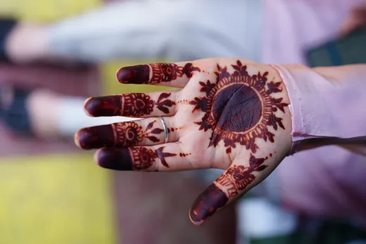 Close up of a woman s hand featuring intricate - henna on skin