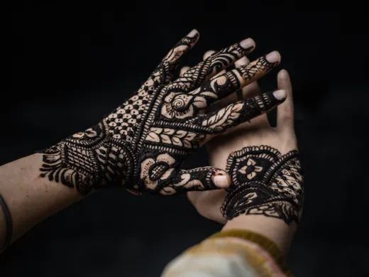 Close up of detailed henna artwork on hands sy - henna on skin