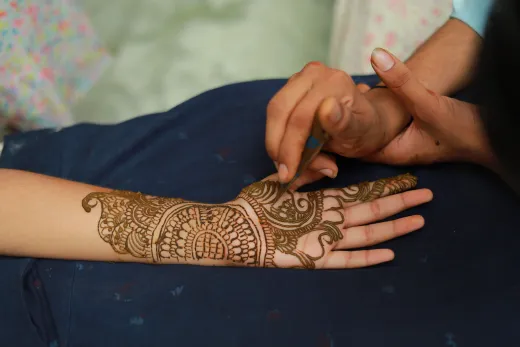 A detailed henna mehndi design being applied o - henna stain