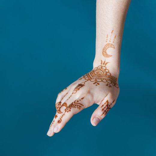 Woman hand with wonderful mehndi draws - simple Arabic mehndi design